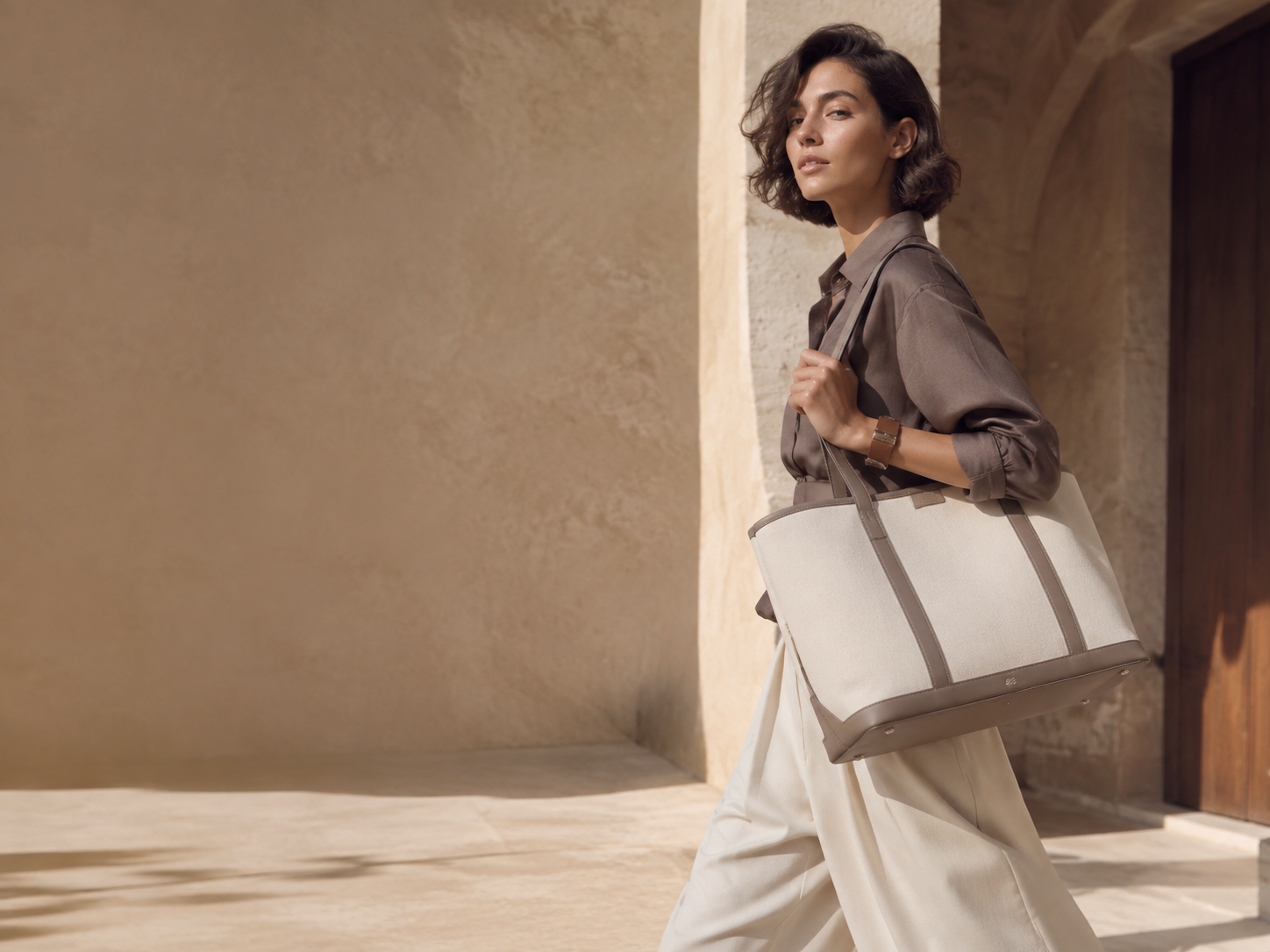 Woman carrying a cream tote bag